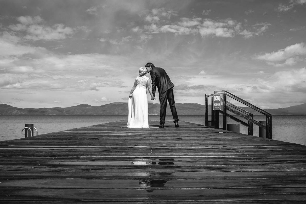 Emerald Bay Elopement couple kiss lakeside dock